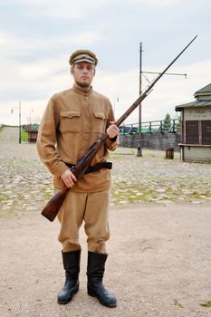 Soldier with a gun in uniform of World War I. Costume accord the times of World War I. Photo made at cinema city Cinevilla in Latvia.