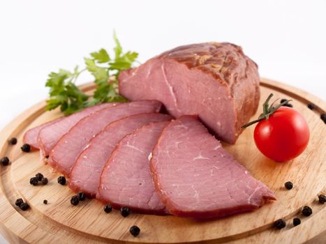 Sliced ham on a wooden board 