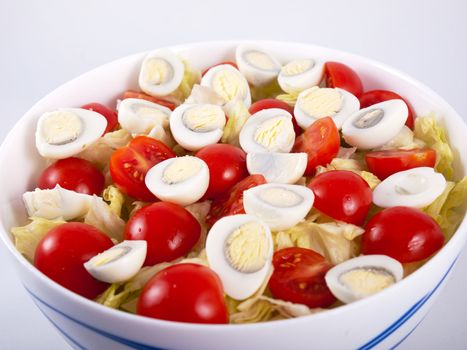 Lettuce, egg and tomato salad in a bowl