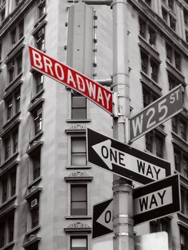 red broadway sign in a black and white photo of new york city signs