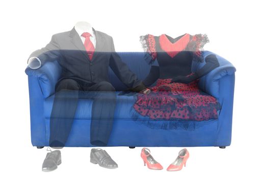 Ghosts of the man in classic suit and woman in red dress are sitting on a blue couch. Conceptual photo about the love in afterlife . Isolated over white