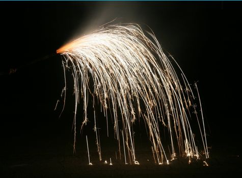 Handheld fireworks streaming to the ground and bouncing