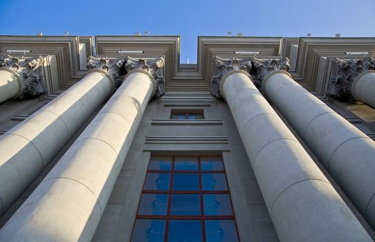 Stalinist architecture. Corinthian capitals and columns. Prospectively on a background of blue sky.