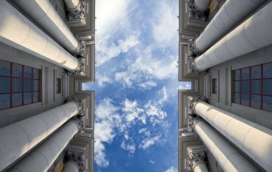 Stalinist architecture. Corinthian capitals and columns. Prospectively on a background of blue sky.