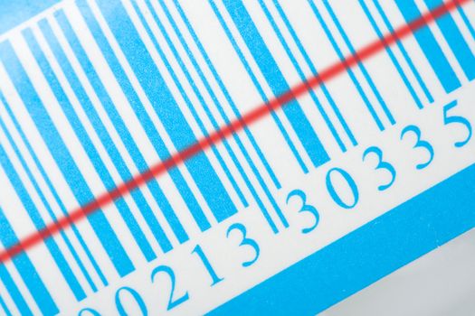 close-up blue barcode with red laser strip