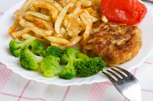 close-up potatoes with cutlet and broccoli, on table-cloth