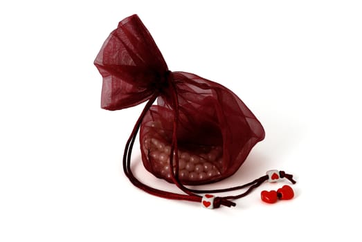 Valentine day gift, beads in pouch on white background