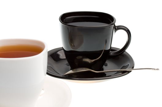 close-up white and black cups with tea, isolated