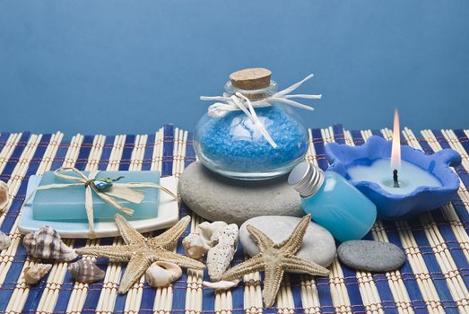 Spa background with hygiene and decorative items in blue.