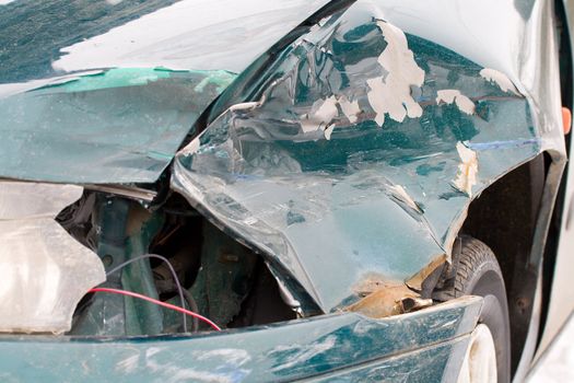 close-up damaged green car