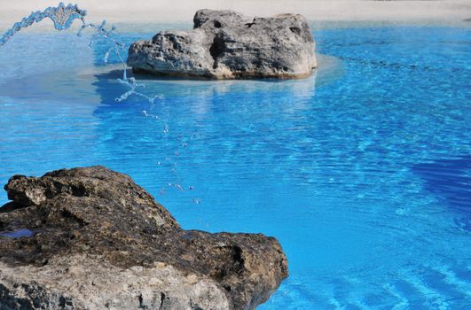 water spray from a fountain in a man made blue lagoon