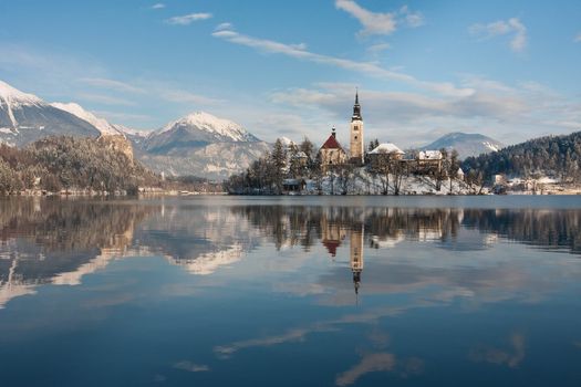 View on lake Bled with small island with church and castle on rock in Slovenia, Europe.