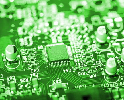 close-up microchip on green circuit board