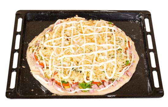 raw pizza on baking tray, isolated on white