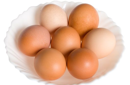 seven eggs on plate, isolated over white