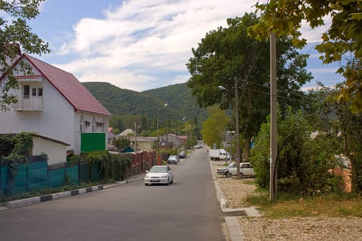 A small village in  mountains, Krasnodar Region, Russia. The street car rides.