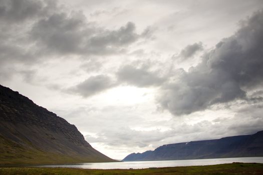 Dark clouds on the sky. View on Dynjandisvogur fjord - Iceland.