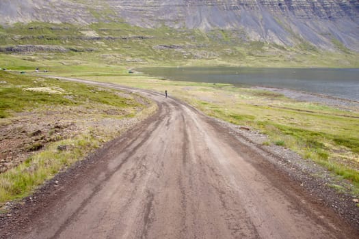 Empty gravel route to Dynjandi waterfall on Iceland in Westfjords.