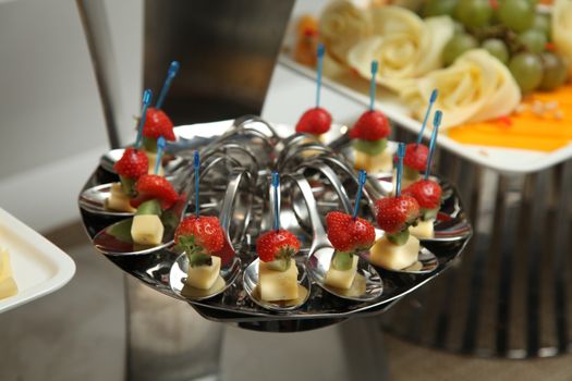 served on metal trays with strawberries and canapes Cheese (Buffet)