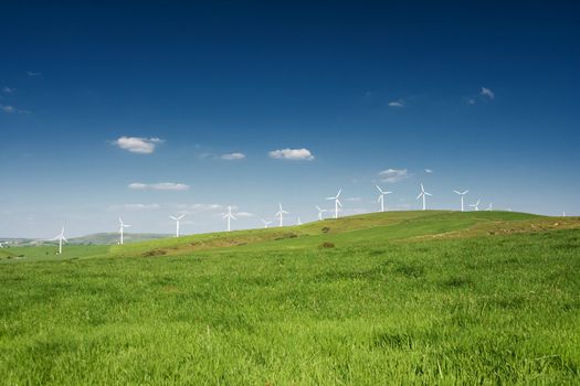 Wind turbines farm on the hills in Wales, UK. Alternative energy source. 