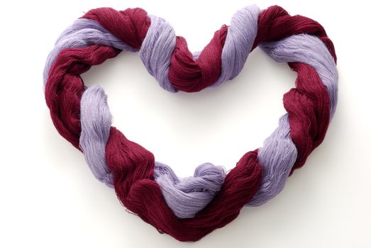 Skein of bicolored wool in shape of heart