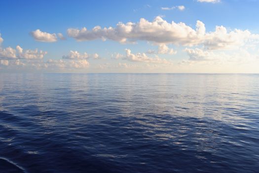 Photo of the calm Pacific ocean during the late afternoon.
