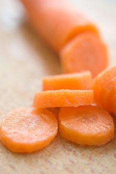 Chopped carrot in circles on wood board