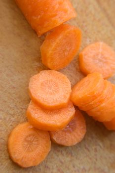 Chopped carrot in circle on wooden board