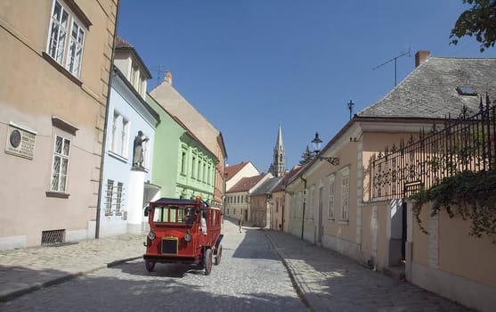 old historic tourist taxi going through Old town in Bratislava, capital city of Slovakia