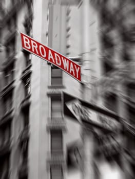 red broadway sign, black and white photo, zoom blur
