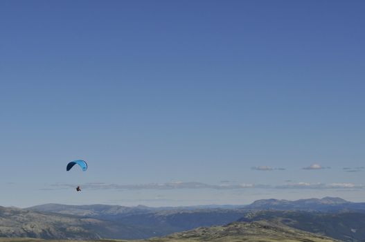 a paraglider over the mountains