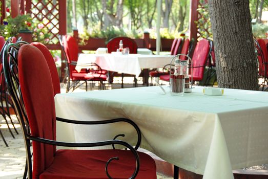 restaurant terrace with metallic chairs and tables outdoor
