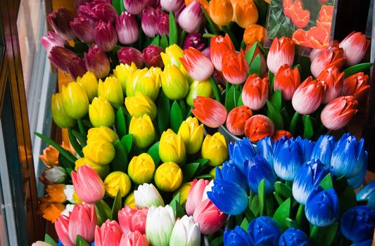 Colorful wooden tulips in different colors offered in Dutch shop for sale as a souvenir 
