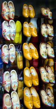 Window display with Dutch wooden shoes in different colors and sizes for sale as a souvenir