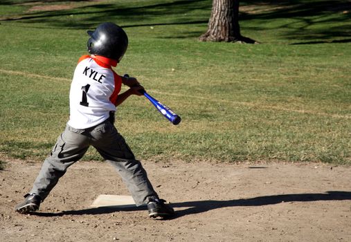 Child trying to hit the ball out of the ballpark