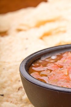 fresh salsa in a black bowl and corn chips 