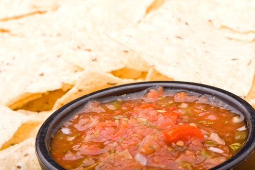 fresh salsa in a black bowl and corn chips 