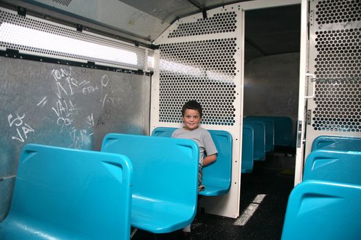 Juvenile delinquent in the police transportation bus