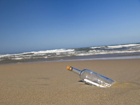 A message in a bottle abandoned on a beach.