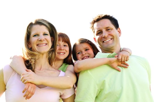 Portrait of happy family giving children piggy back rides