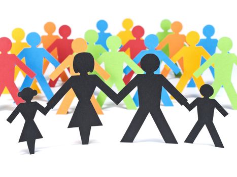 A paper family holding hands in front of a group of multicolor paper men.