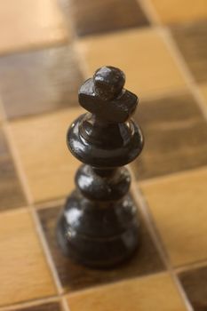 black wooden chess king figure, distance blur