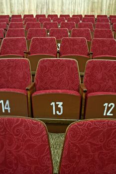 purple empty cinema seats with white numbers,