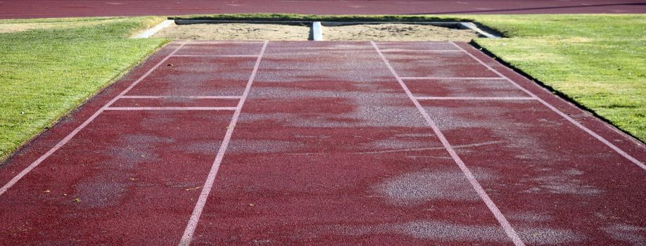 Artificial turf leads to a sand pit for long jumping