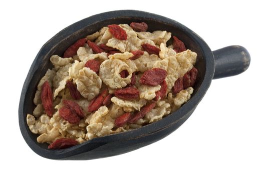 light rice cereal with red dried Tibetean goji berries (wolfberry) on a rustic wooden scoop isolated on white