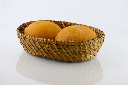  fresh baked rolls in a basket on white