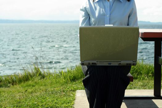 Businesswoman working outdoor near the beach