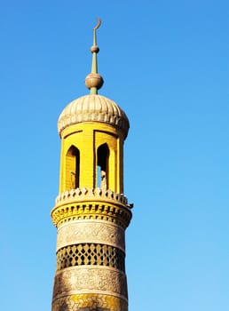 Landmark of the yellow roof of a famous mosque with blue sky as background