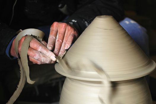 Making a porcelain vase with clay,ready for firing in a kiln