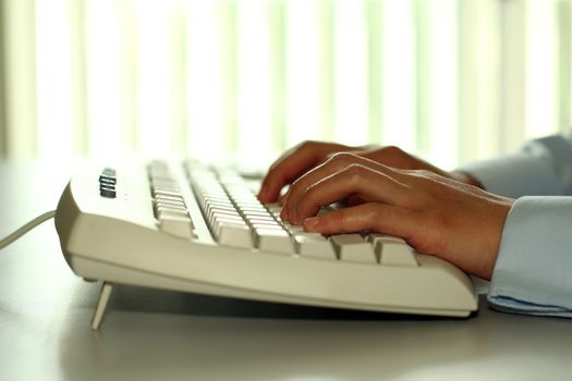 A business person yping on a keyboard